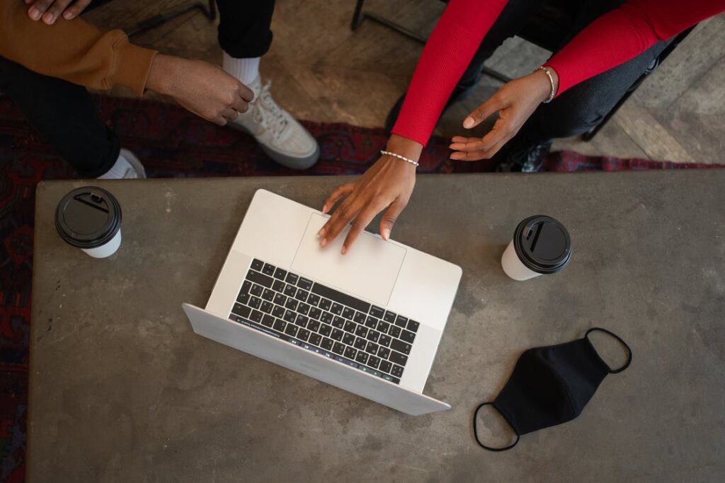 People gathered around a laptop - discussing internet safety